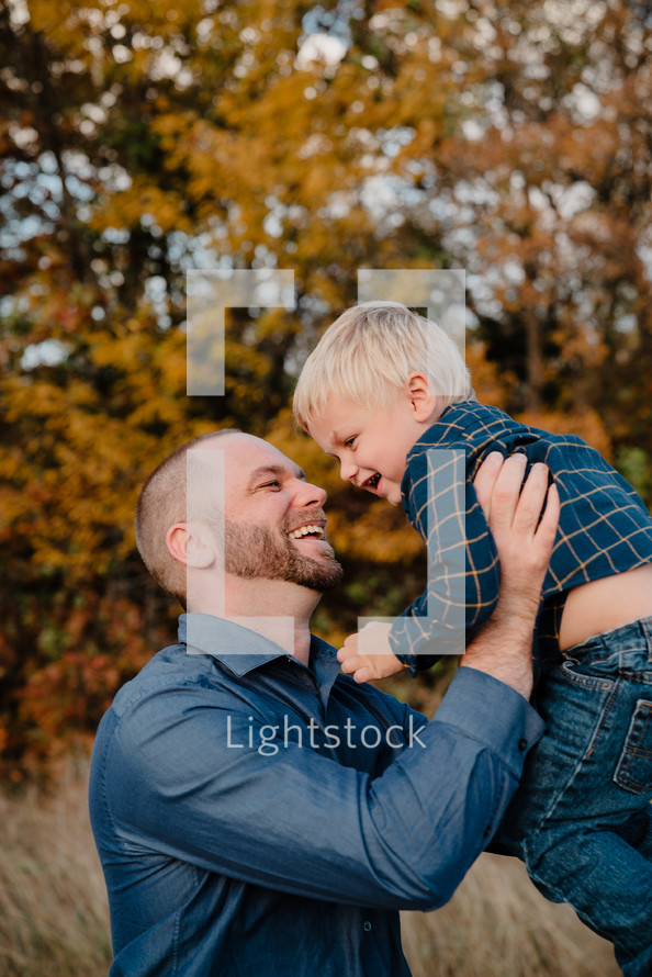 portrait of a loving father and son outdoors in fall 