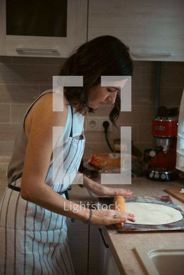 a woman baking in a kitchen 