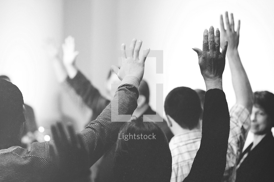 congregation with raised hands in worship 