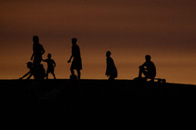 silhouettes of boys on a beach 