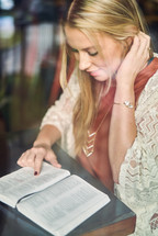 a woman reading a Bible