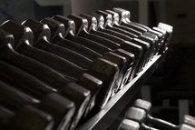 barbells racked in a gym.