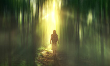 a woman with a backpack standing in a glowing forest 