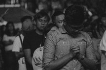 youth praying at a conference 