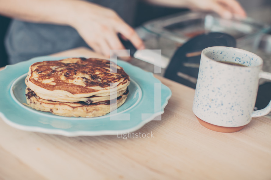 pancakes on a plate and coffee mug