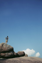 man standing on top of a rock 