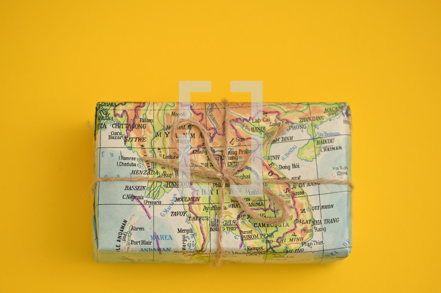 world map wrapping paper on a gift 