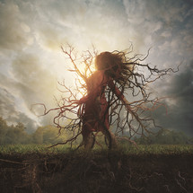 A woman is stuck to the earth and rooted into the ground.