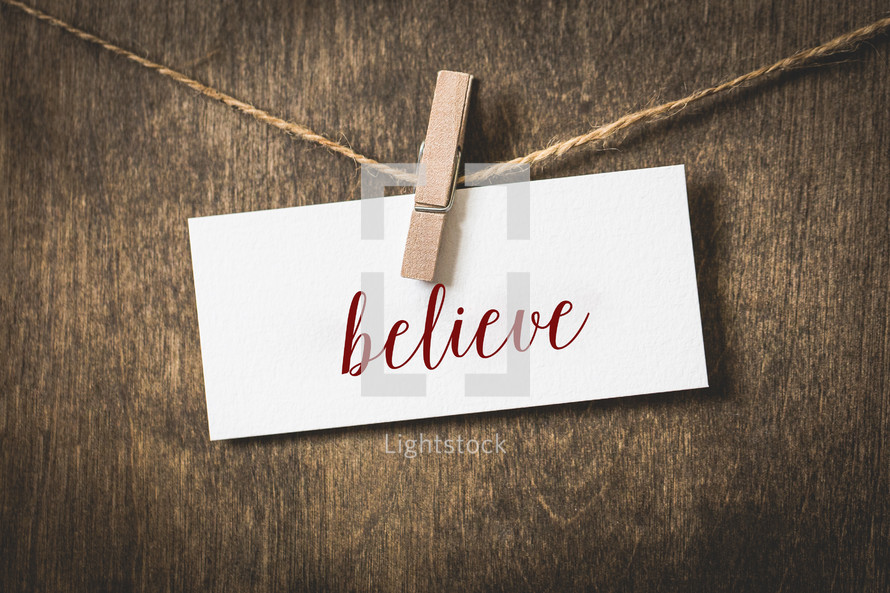 word believe on white card stock hanging from a clothespin on a clothesline 
