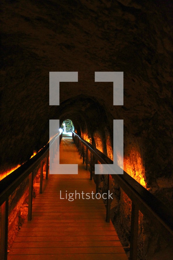 A walkway through an underground tunnel.