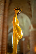 A statue of Virgin Mary in a cathedral environment 