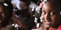 faces of smiling girls in Haiti 