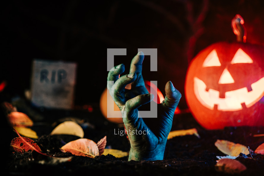 Terrible zombie hand climbs out of grave. Creepy moment from undead life. Halloween concept. Living nightmare comes to life. High quality