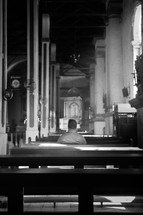 a man sitting in an empty church 