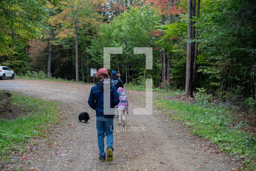 Family hiking in the fall trees