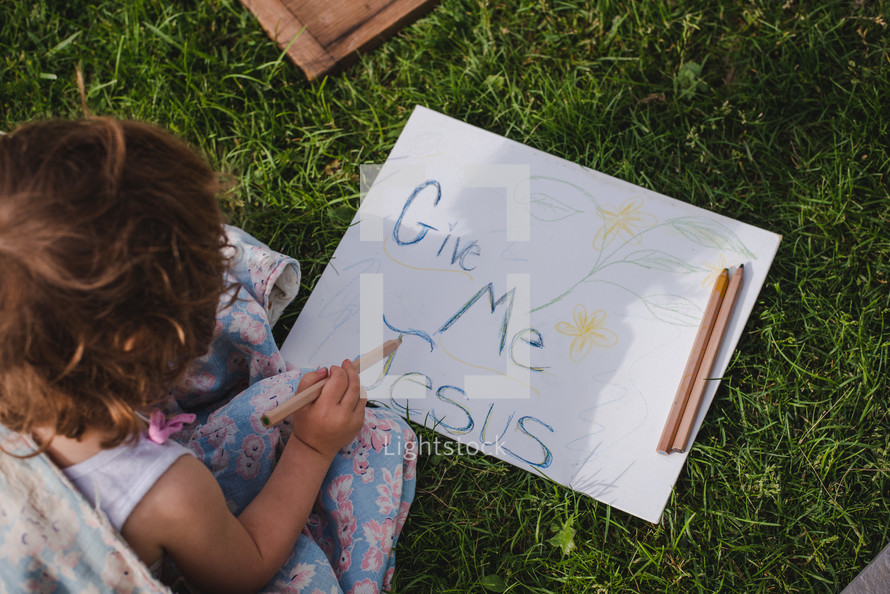 a child drawing a give me Jesus sign 