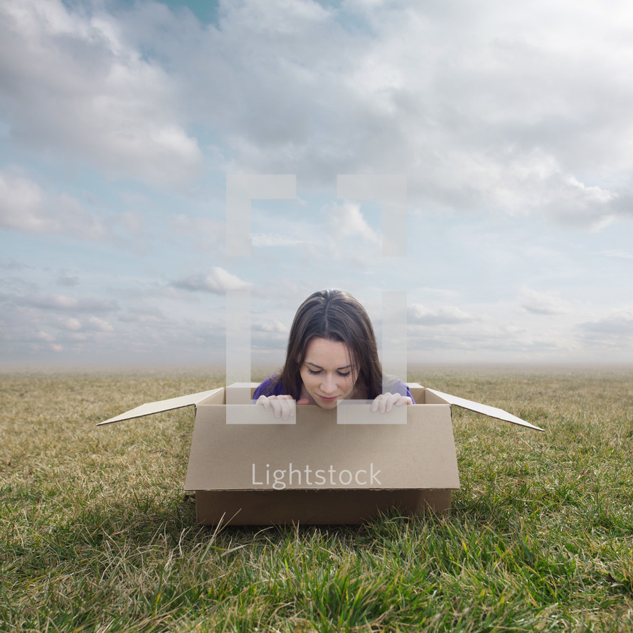 woman climbing out of a box 