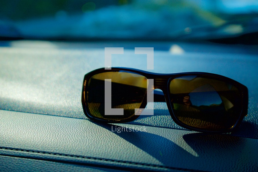 sunglasses on a dashboard 