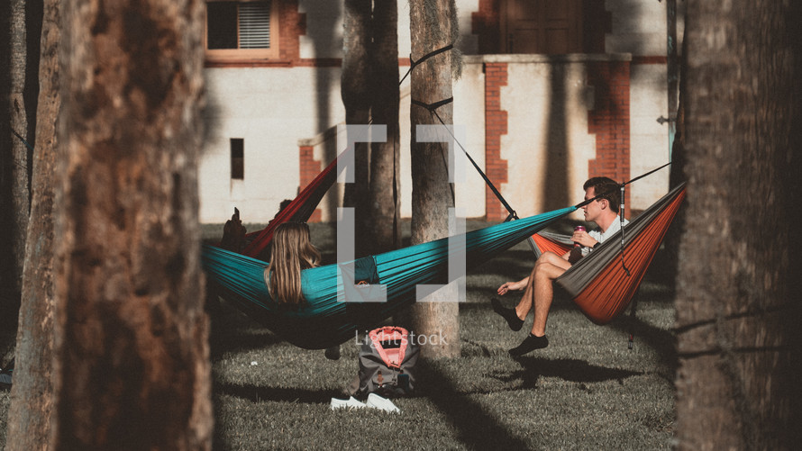 people in a park relaxing in hammocks 