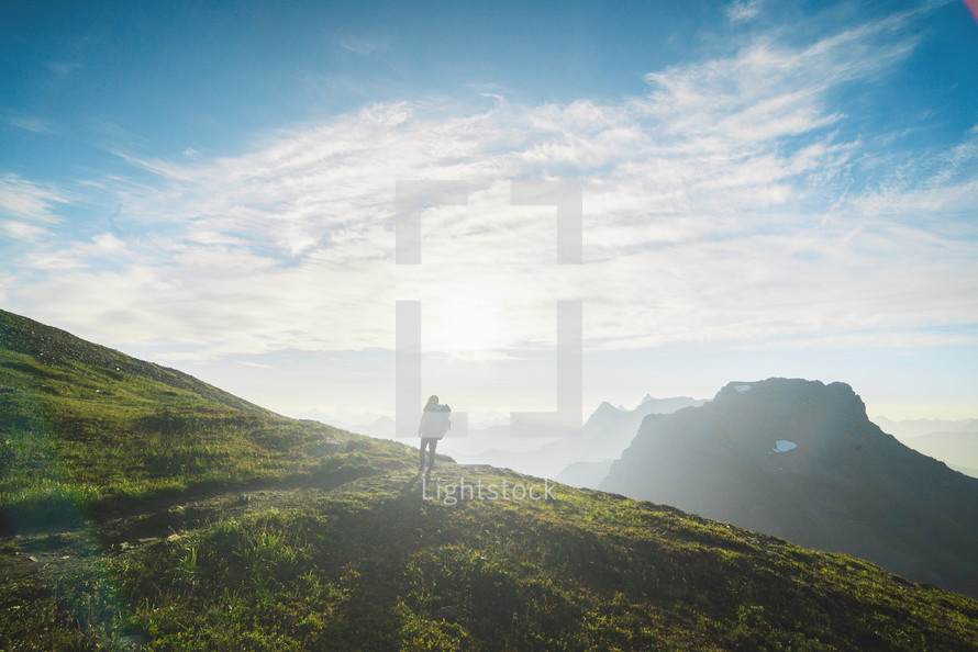 man on a mountaintop at sunrise 
