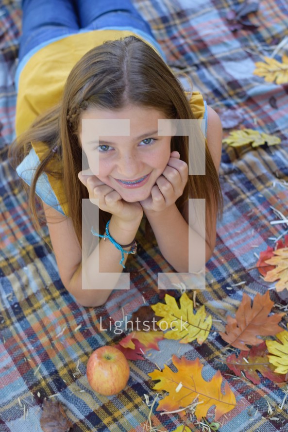 teen girl portrait on a plaid blanket 