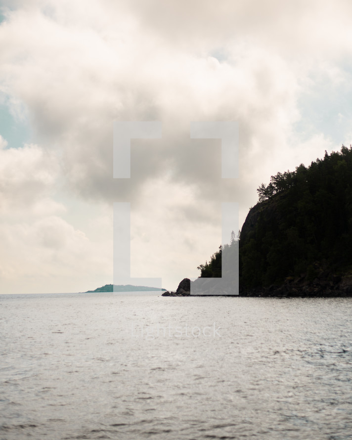 The silhouette of a tree-covered island