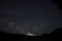 snow covered mountain peak under the night sky