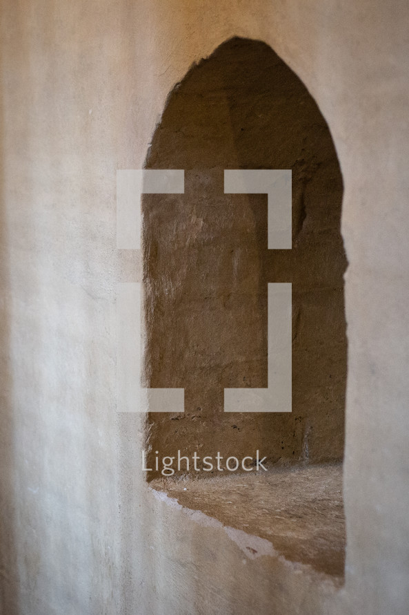 A window arch in a stone wall