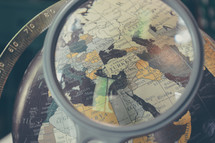 magnifying glass over a globe 