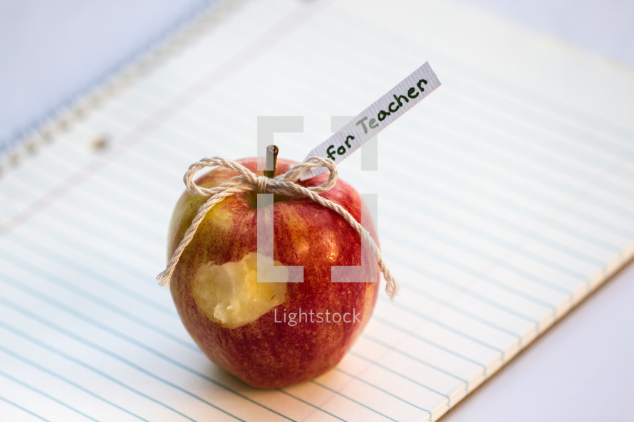 an apple for the teacher on a notebook 