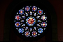 Circular stained glass window depicting the signs of each of the 12 disciples in an Anglican Cathedral