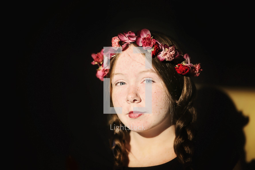 freckled face girl child with braid hair and crown of flowers 