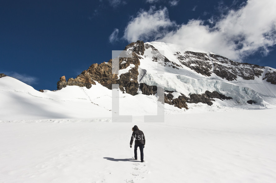a man hiking up a snowy slope 