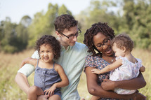 Happy multi-racial family outdoors. 