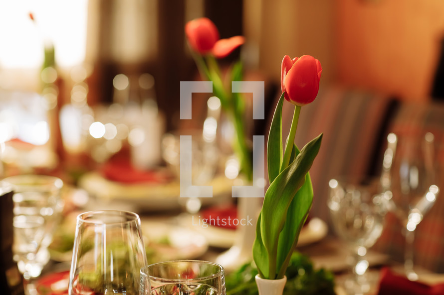 festive set table for the holiday with tulips flowers. High quality photo.