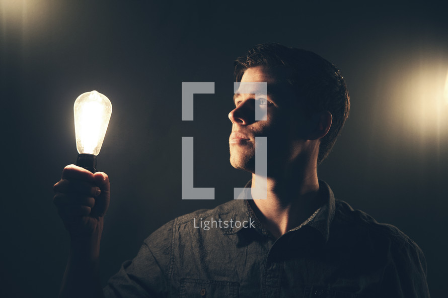 man holding a lightbulb 