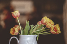vase of orange and yellow tulips 