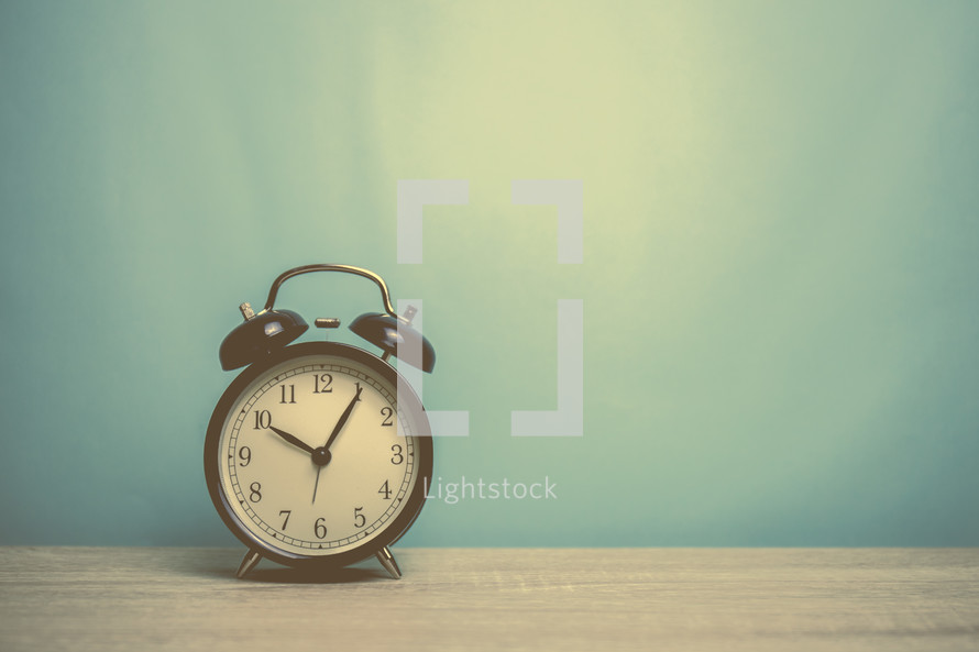 alarm clock on a wood table 
