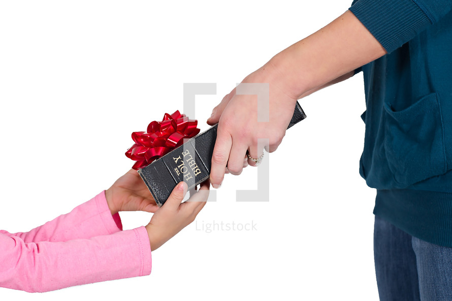  woman giving a Bible with a red bow