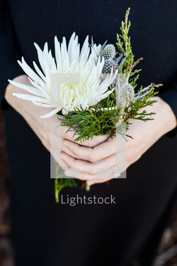 a woman holding picked flowers 
