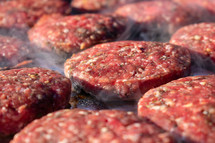 raw hamburger meat on a grill 