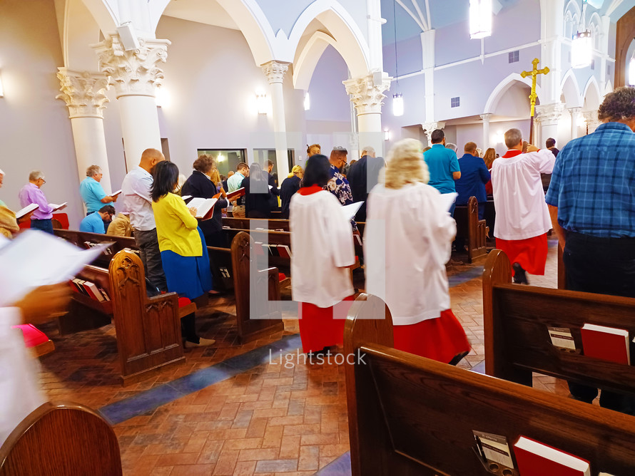 Choir in red robes entering church