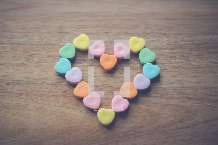 heart shaped candy in the shape of a heart on wood 