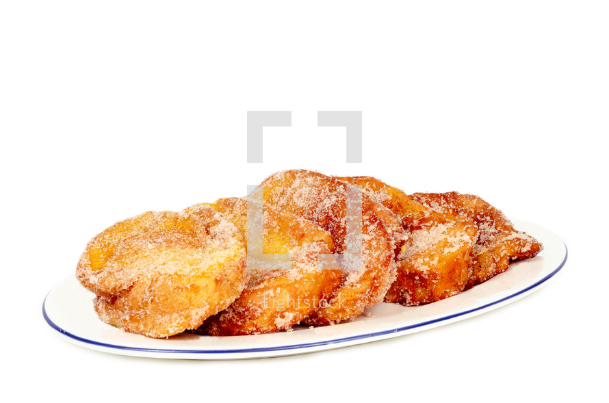 closeup of a plate with torrijas isolated on white background. Typical spanish dessert for Lent and Easter.
