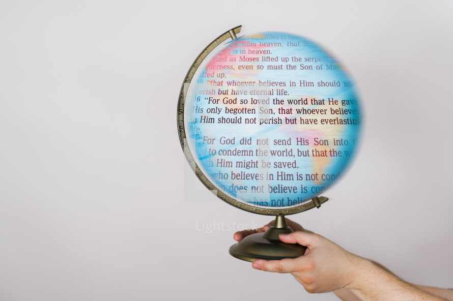 Hands holding a globe with the words of John 3:16 on it.
