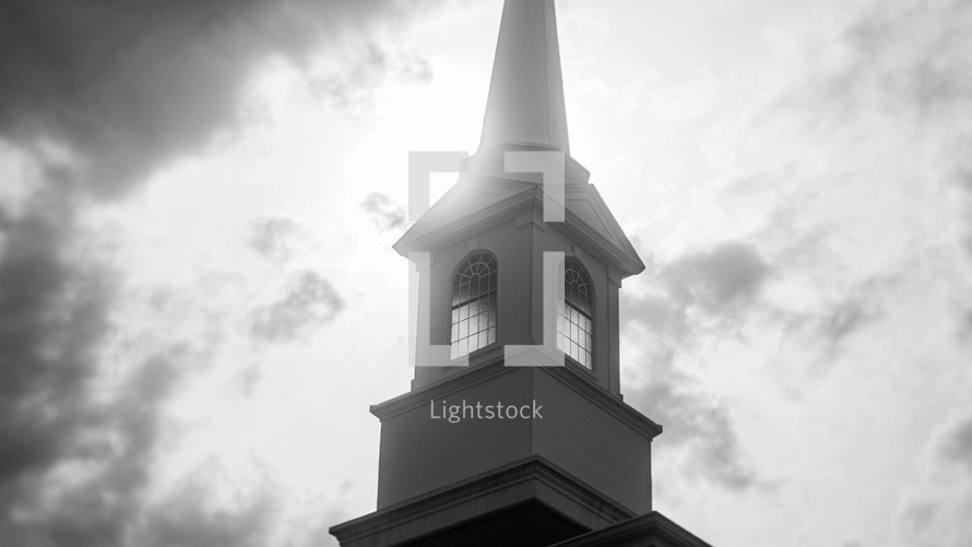 steeple against clouds - black and white