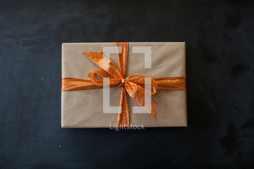 a wrapped present with an orange bow 