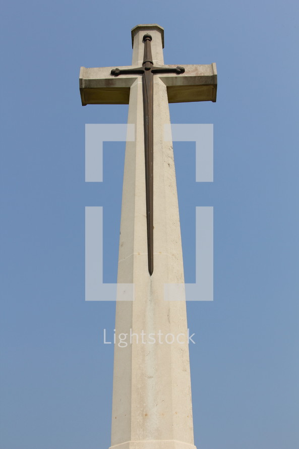 Christian cross and sword at war memorial graveyard 