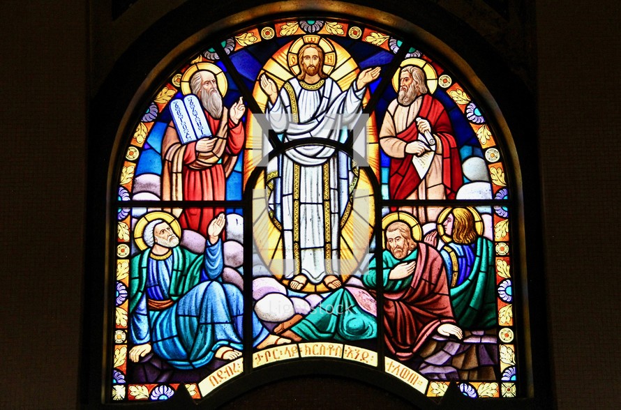 Stained glass window depicting the transfiguration of Jesus between Moses and Elijah 
