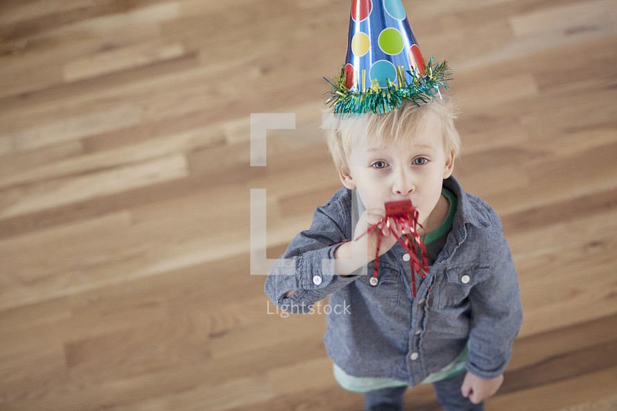 A toddler wearing a party hat